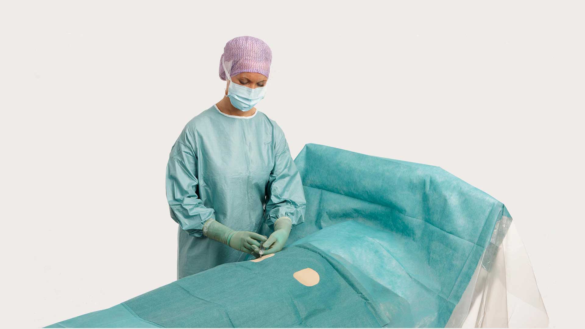 a surgeon using a BARRIER angiography drape for an operation
