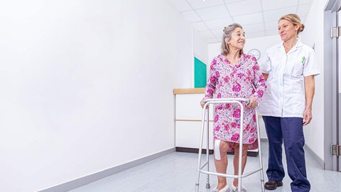 nurse standing with patient in hospital setting