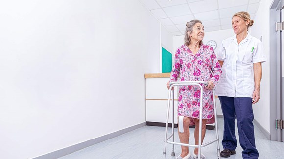 nurse standing with patient in hospital setting