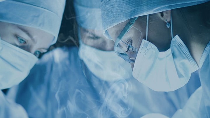 Surgeons during operation and surgical plume